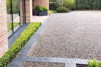 Clipped Buxus hedge softening the architecture